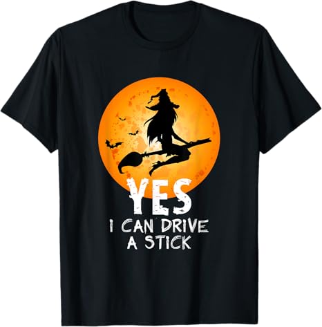 Black t-shirt with a witch graphic and 'YES I CAN DRIVE A STICK' text on an orange moon background.